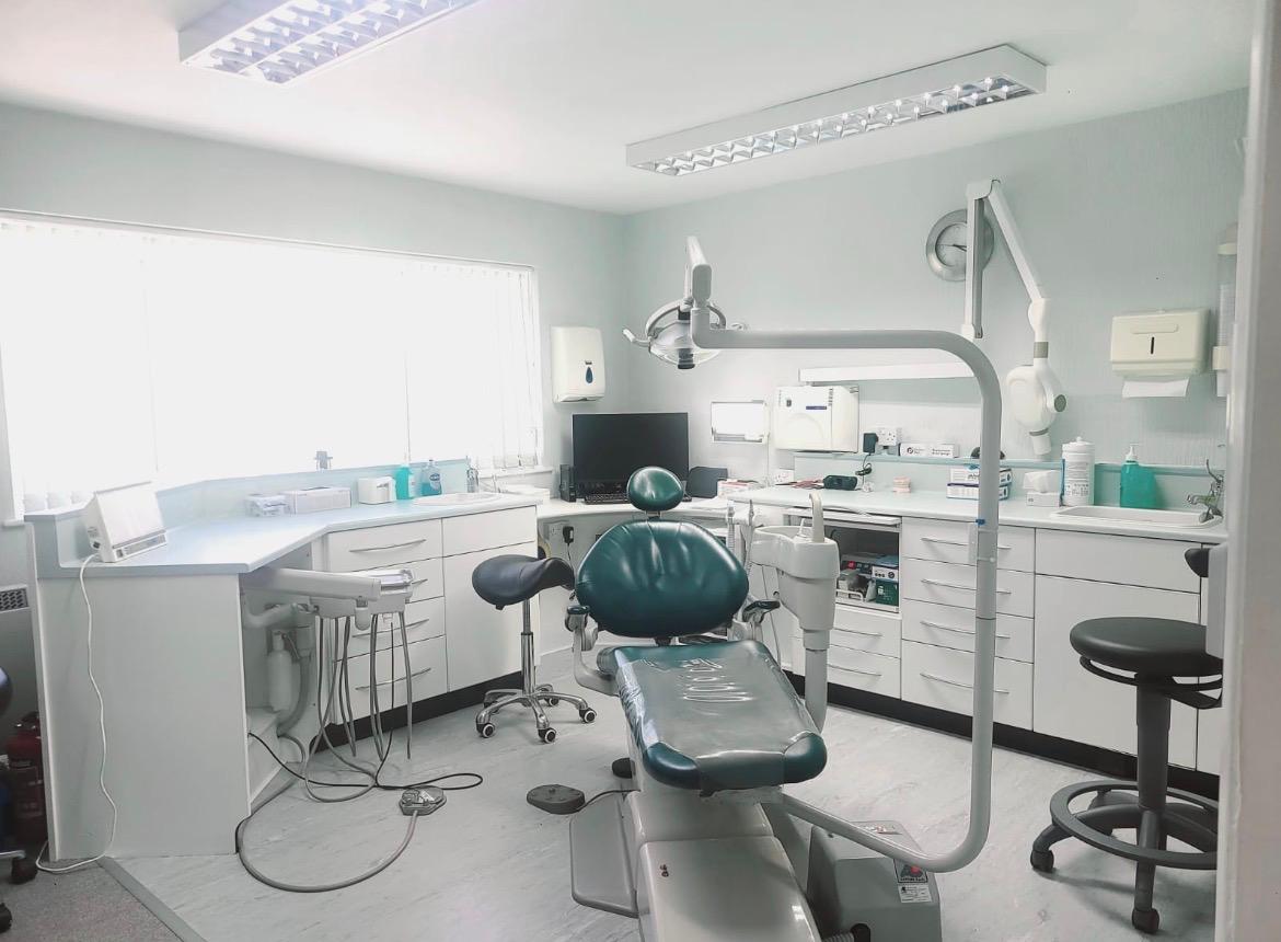 A treatment room at Liphook Smile Studio, with the dental chair, overhead light and worktops